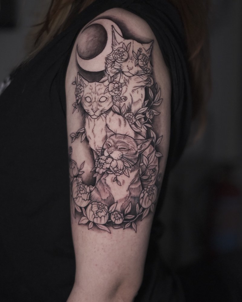 Tatuaje de una calavera con luna y flores en el hombro